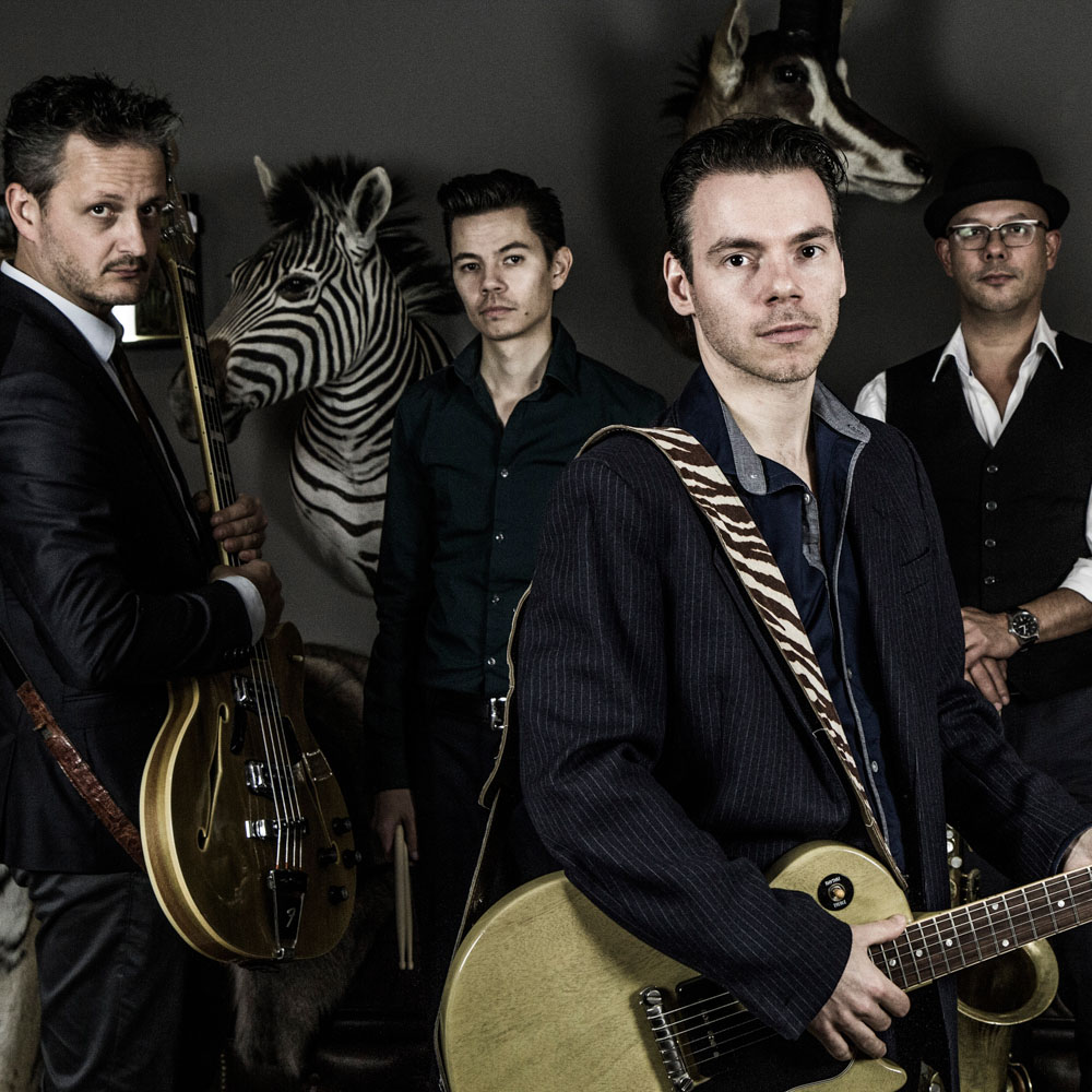 Groep van 5 mannen die verschillende instrumenten vast hebben