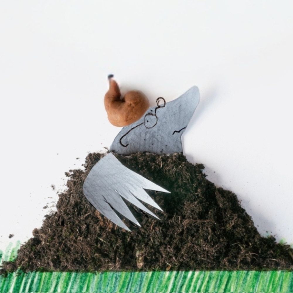 Speelse illustratie van mol in grond met kleipoepje op zijn hoofd.