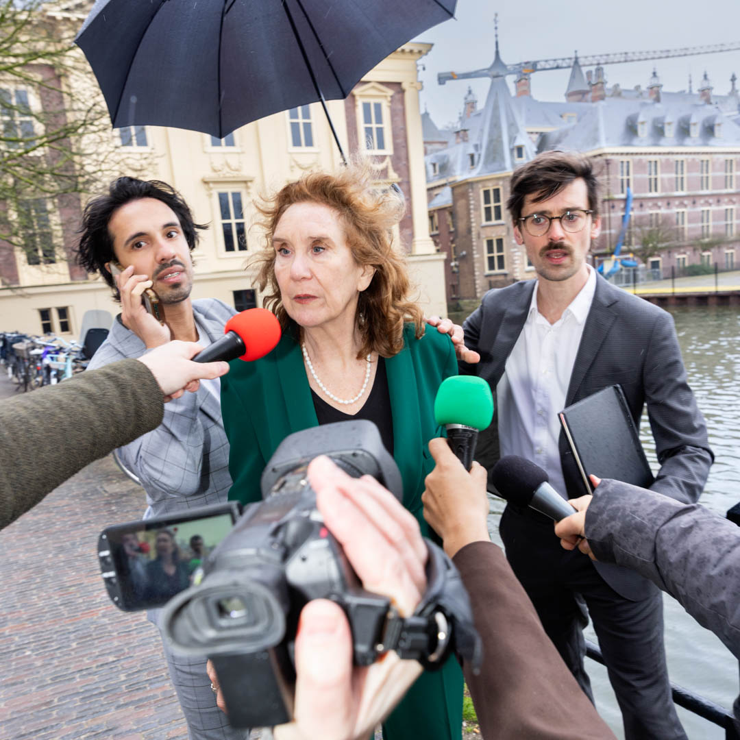 In De Bestorming wordt vrouw belaagd door journalisten met camera’s en microfoons.